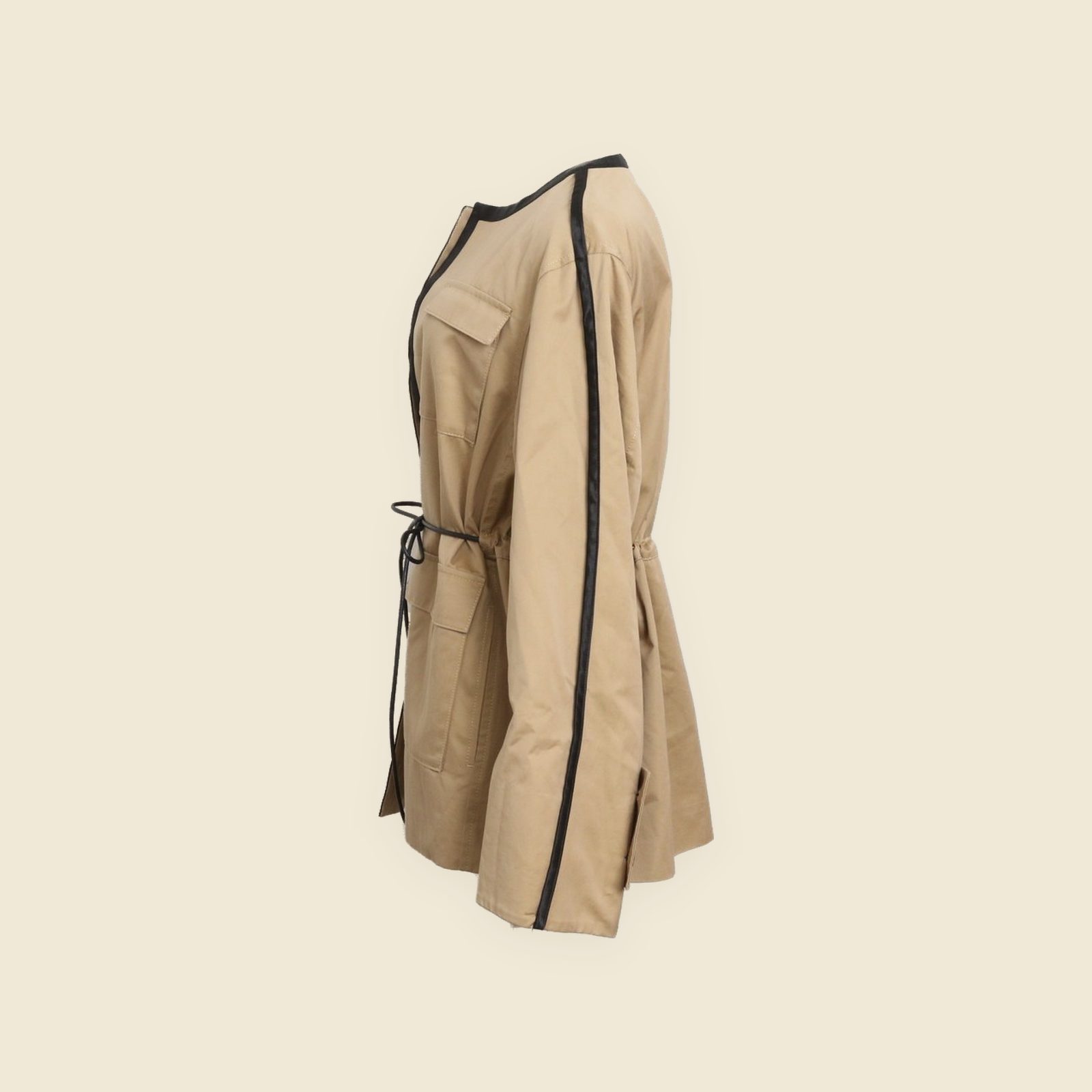 Giacca Cinoh beige senza collo su manichino, con profili neri al girocollo e lungo l'apertura e quattro tasche con pattina — vista 3