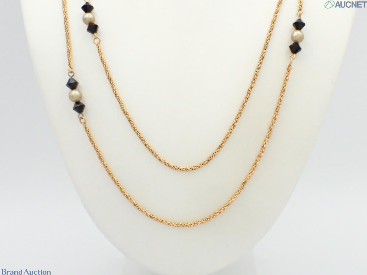 Collana lunga Yves Saint Laurent a catena dorata intrecciata, con perle d'imitazione e perline nere sfaccettate