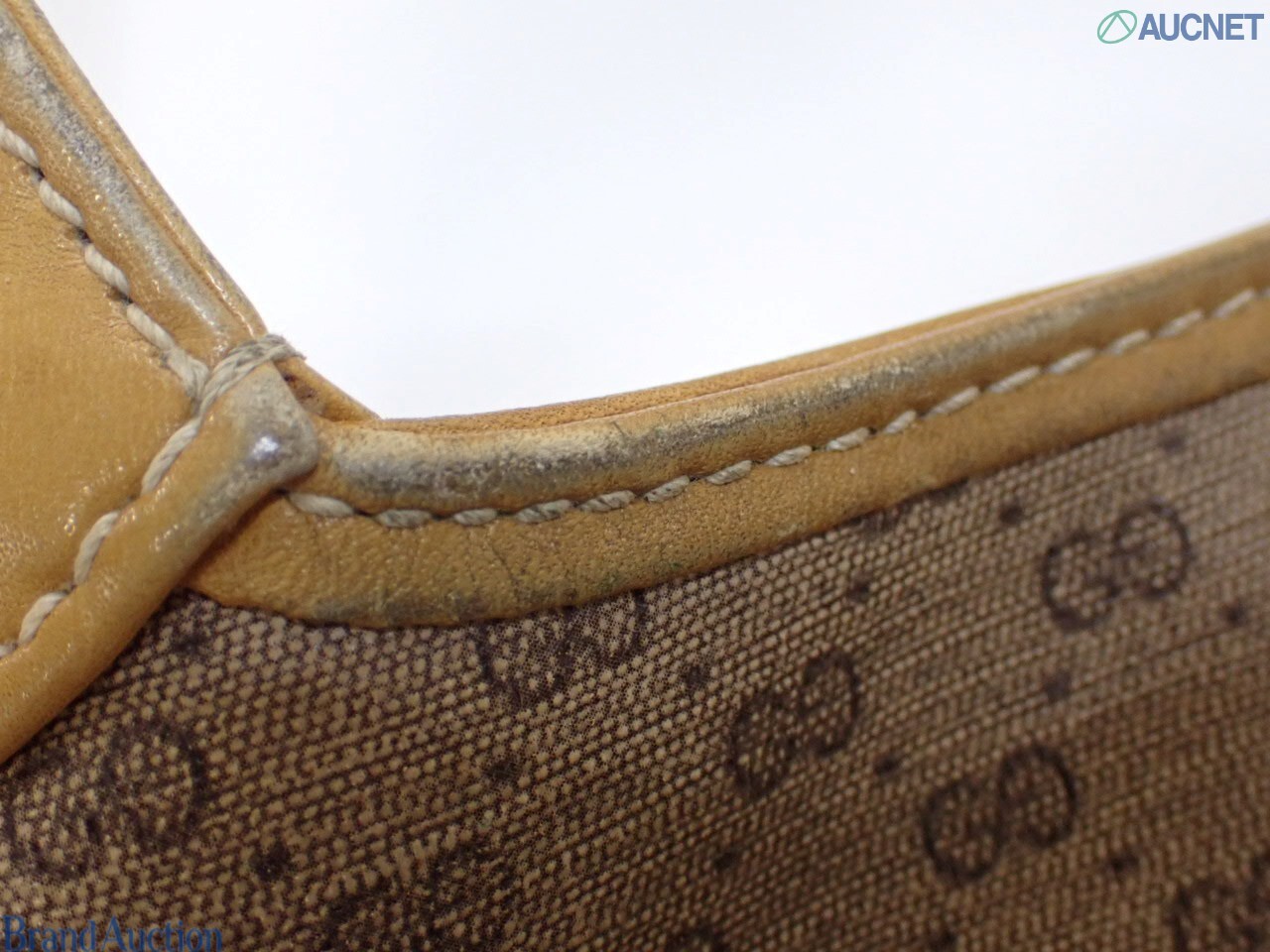 Borsa Gucci con micro motivo GG su fondo beige, finiture color miele e chiusura a pistone dorata, vista frontale — vista 13