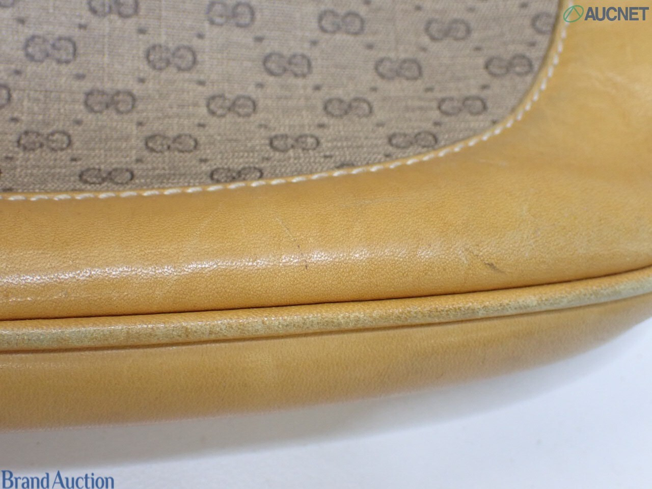 Borsa Gucci con micro motivo GG su fondo beige, finiture color miele e chiusura a pistone dorata, vista frontale — vista 15