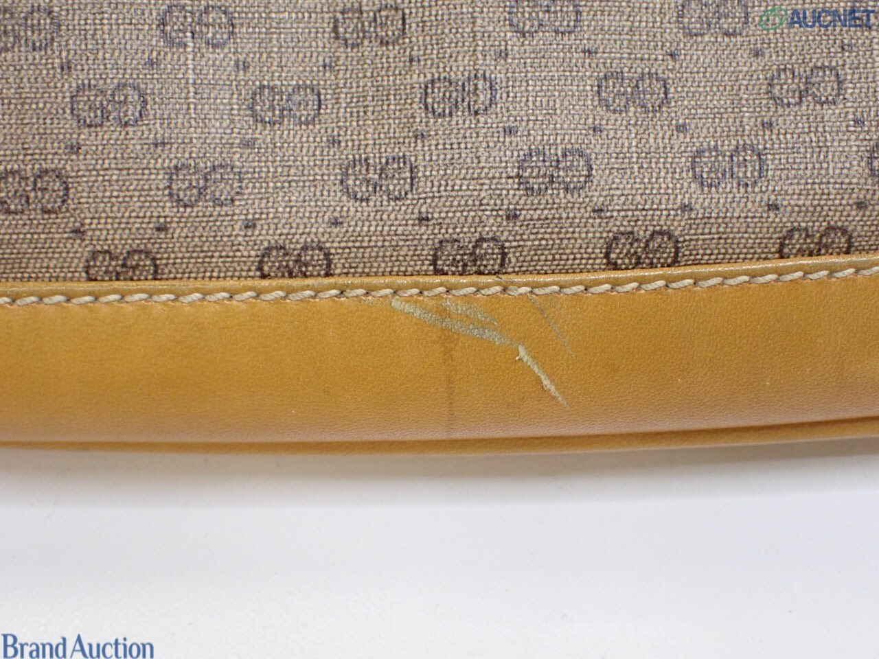 Borsa Gucci con micro motivo GG su fondo beige, finiture color miele e chiusura a pistone dorata, vista frontale — vista 16