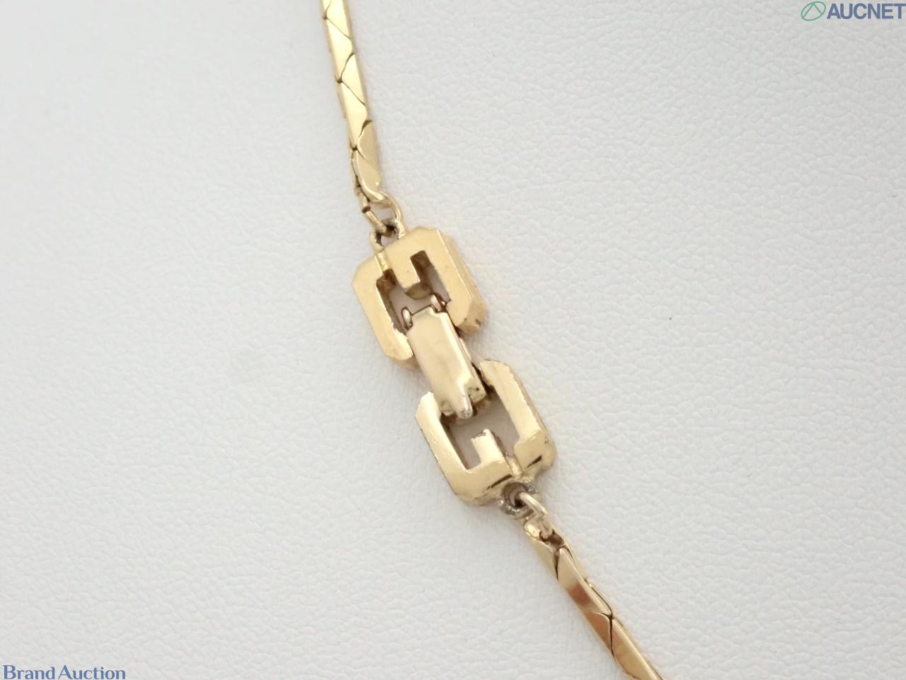 Collana Givenchy a catena dorata piatta con pendente a goccia color ambra marmorizzato e ansa dorata aperta al centro. — vista 2