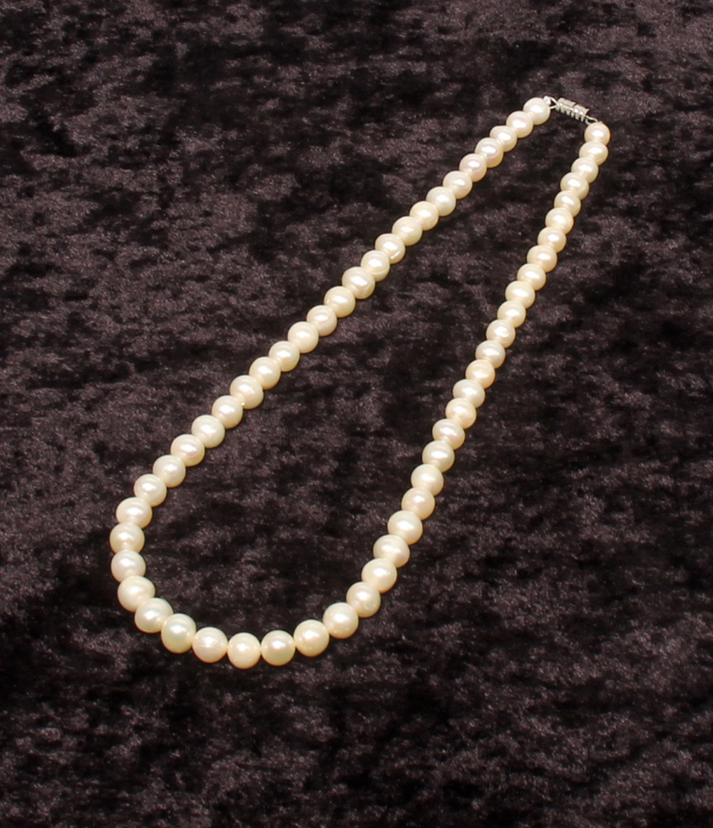 Collana a filo unico di perle d'acqua dolce chiare con chiusura a vite argentata, su velluto scuro — vista 2