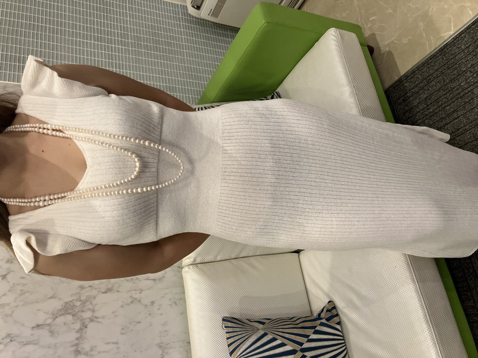 Collana lunga di perle bianche di misura alternata, indossata a doppio giro su un abito bianco a coste — vista 3