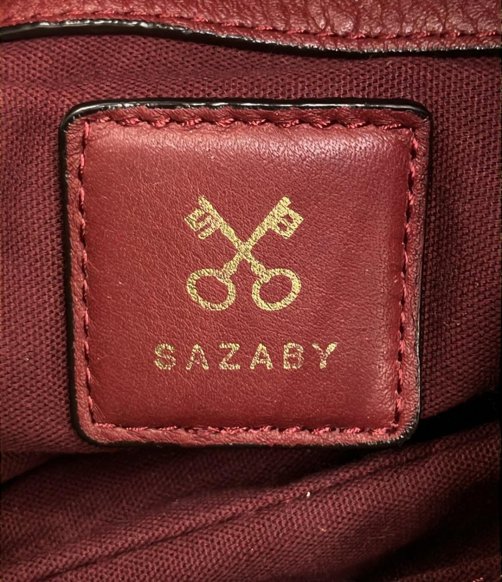 Borsa a spalla Sazaby bordeaux, morbida, con manico intrecciato, anelli dorati e lunga nappa a frange. — vista 5