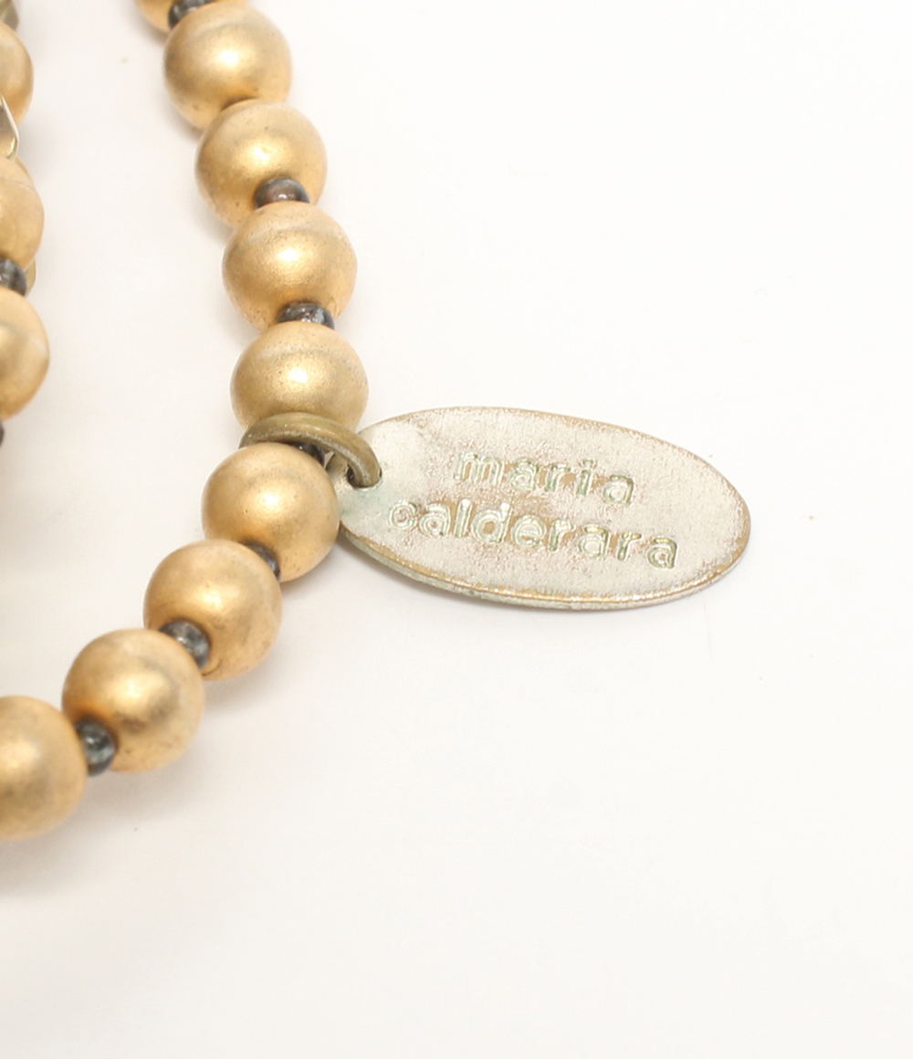 Collana multifilo Maria Calderara di perline sfaccettate e sfere opache color oro, dal champagne al bruno, su fondo bianco — vista 4