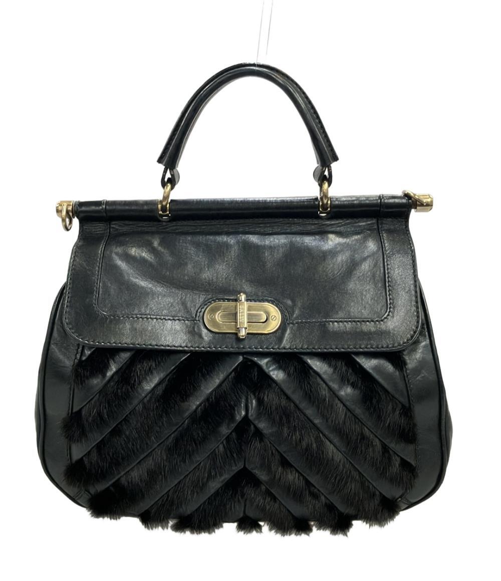 Borsa a mano Bally in pelle nera con manico singolo, chiusura girevole dorata e fasce di pelo scuro a punta sul fronte